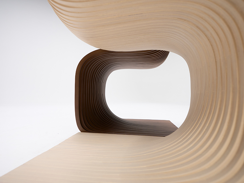 Close-up detail of wooden parametric bench showing precision cnc cuts
