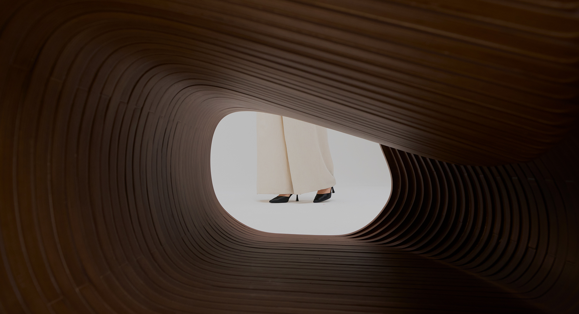 Luxury parametric wooden tunnel structure showcasing fluid architectural design